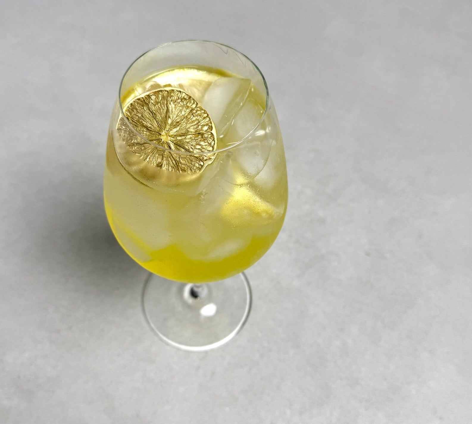 Limoncello spritz with golden garnish