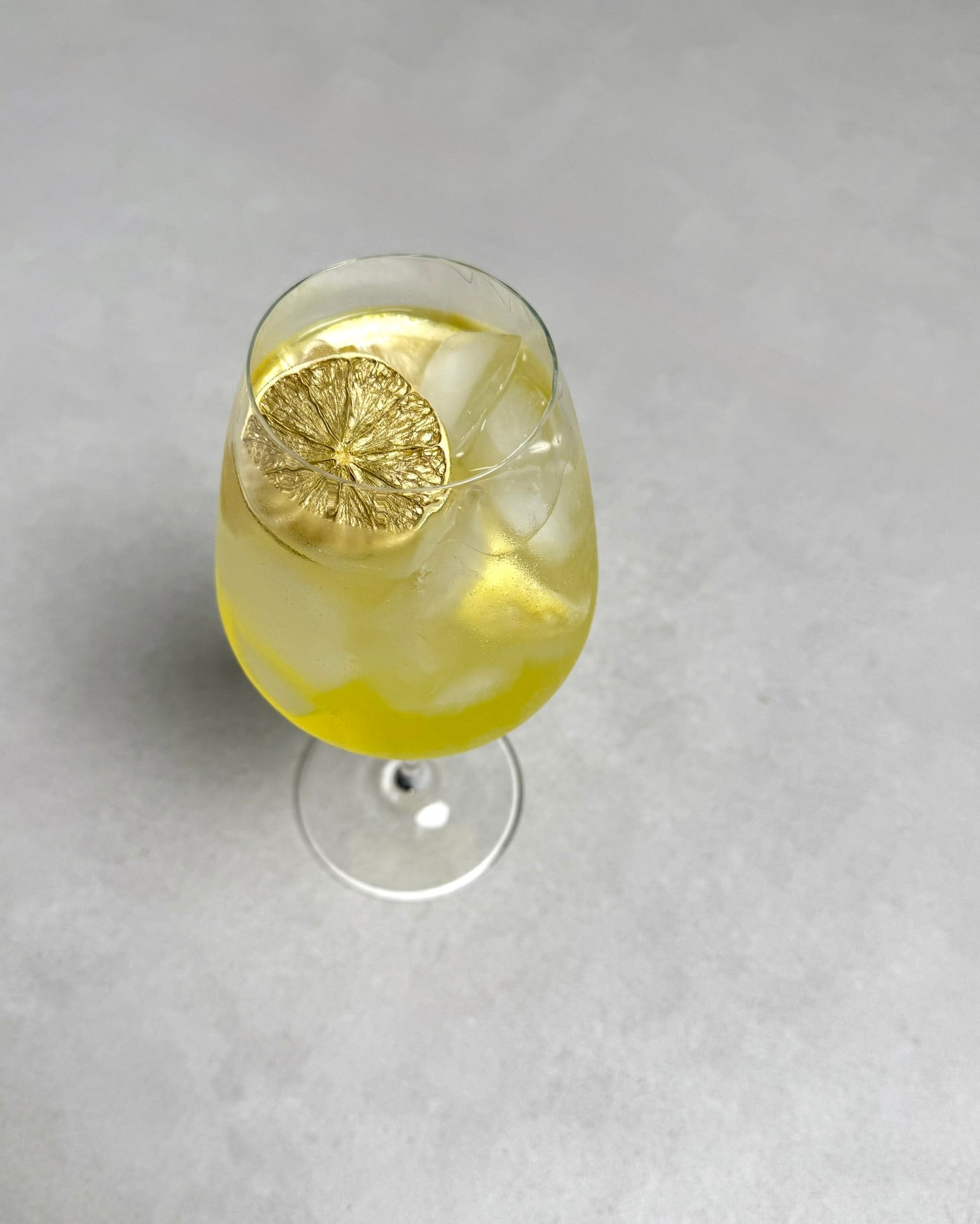Limoncello spritz with golden garnish