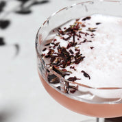 cocktail garnished with shimmering hibiscus 
