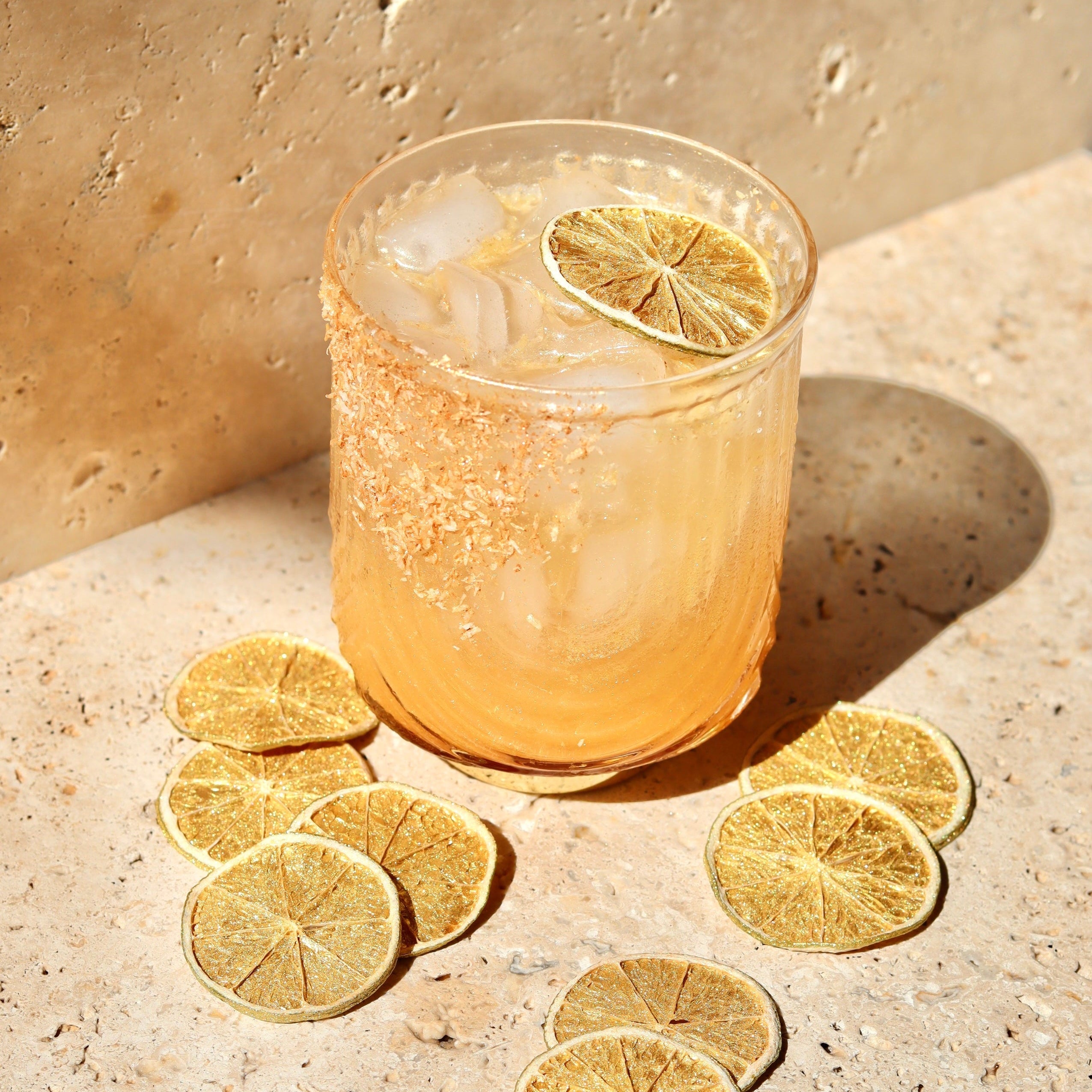 cocktail garnished with glittery dehydrated citrus wheels