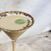 green cocktail garnish on pistachio martini