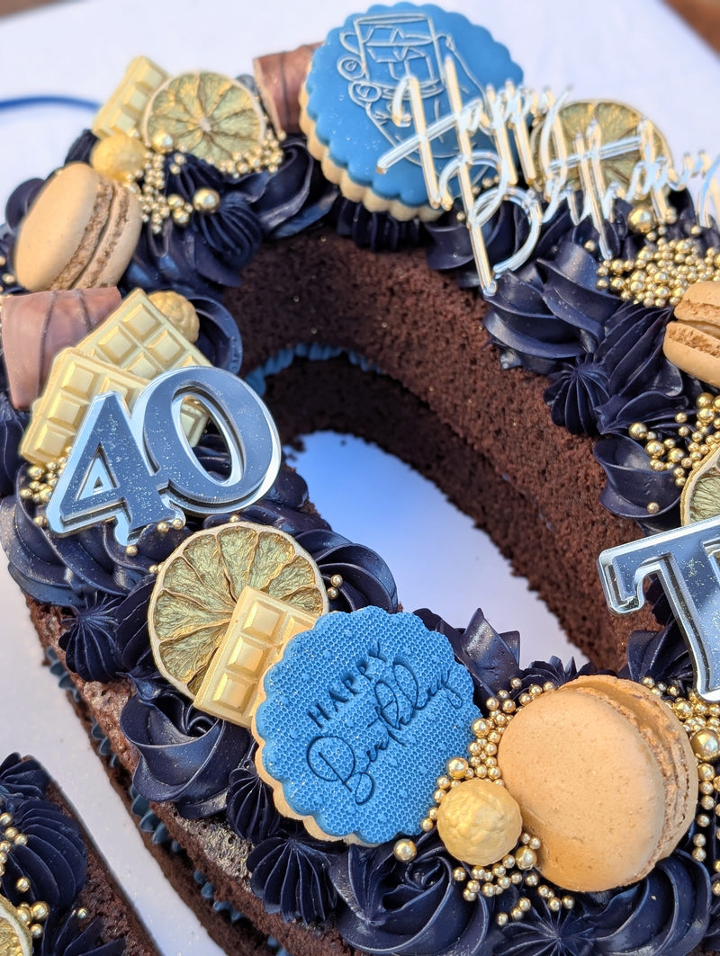 Decorative birthday cake with blue and gold accents