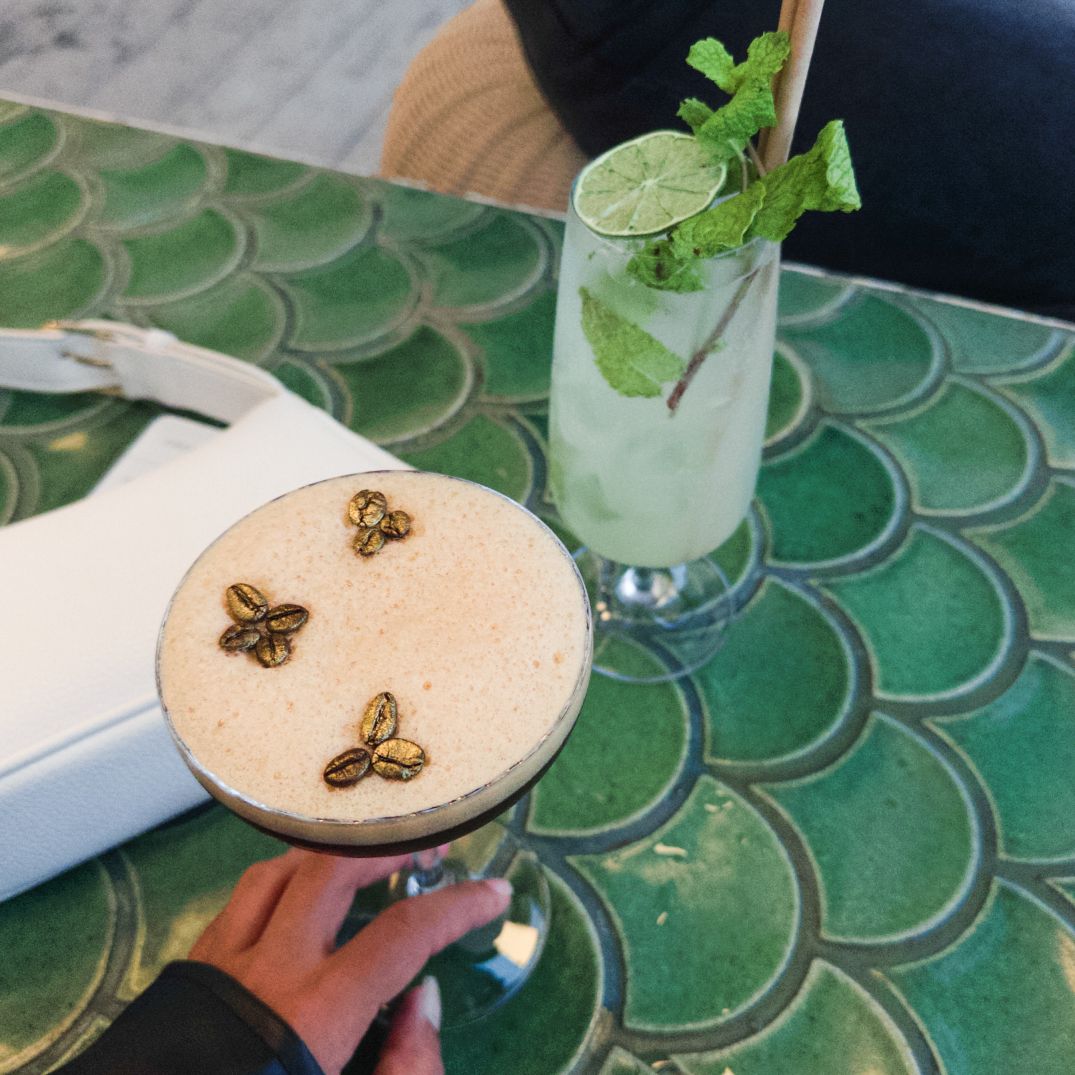 espresso martini and mojito on a table