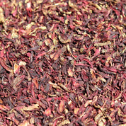 Close-up of dried hibiscus flowers in red and brown hues.