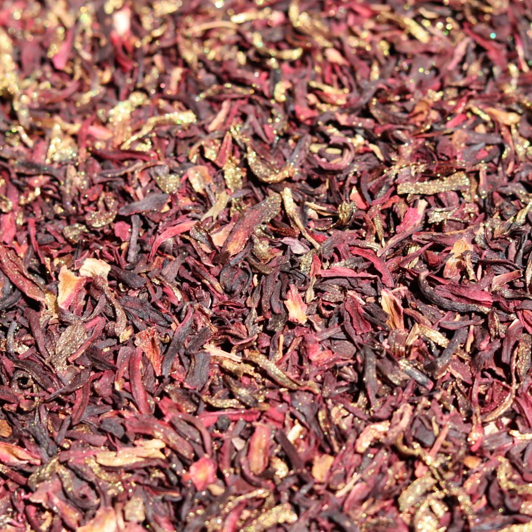 Close-up of dried hibiscus flowers in red and brown hues.