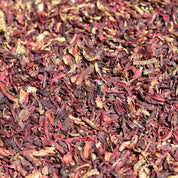 Close-up of dried hibiscus flowers in red and brown hues.
